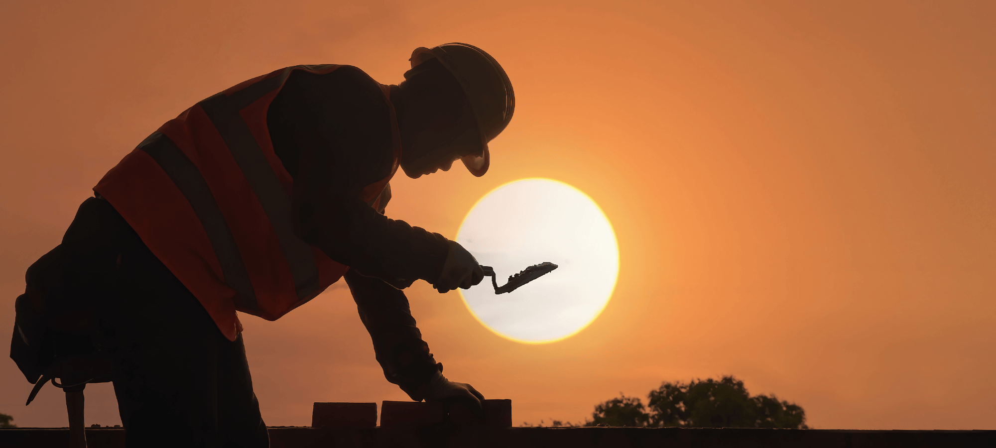 Construction worker building at sunset, symbolizing Site Connected’s integrity and commitment to long-term trust in the construction industry.